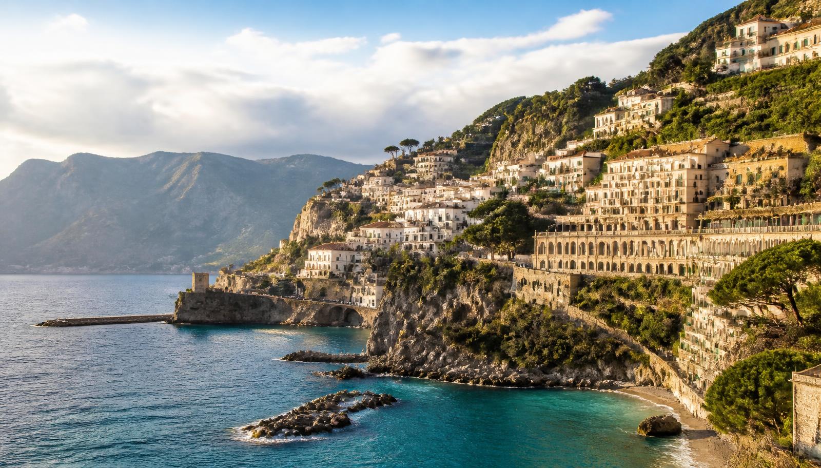 A calm Mediterranean coastline at dusk, an illustrative scene